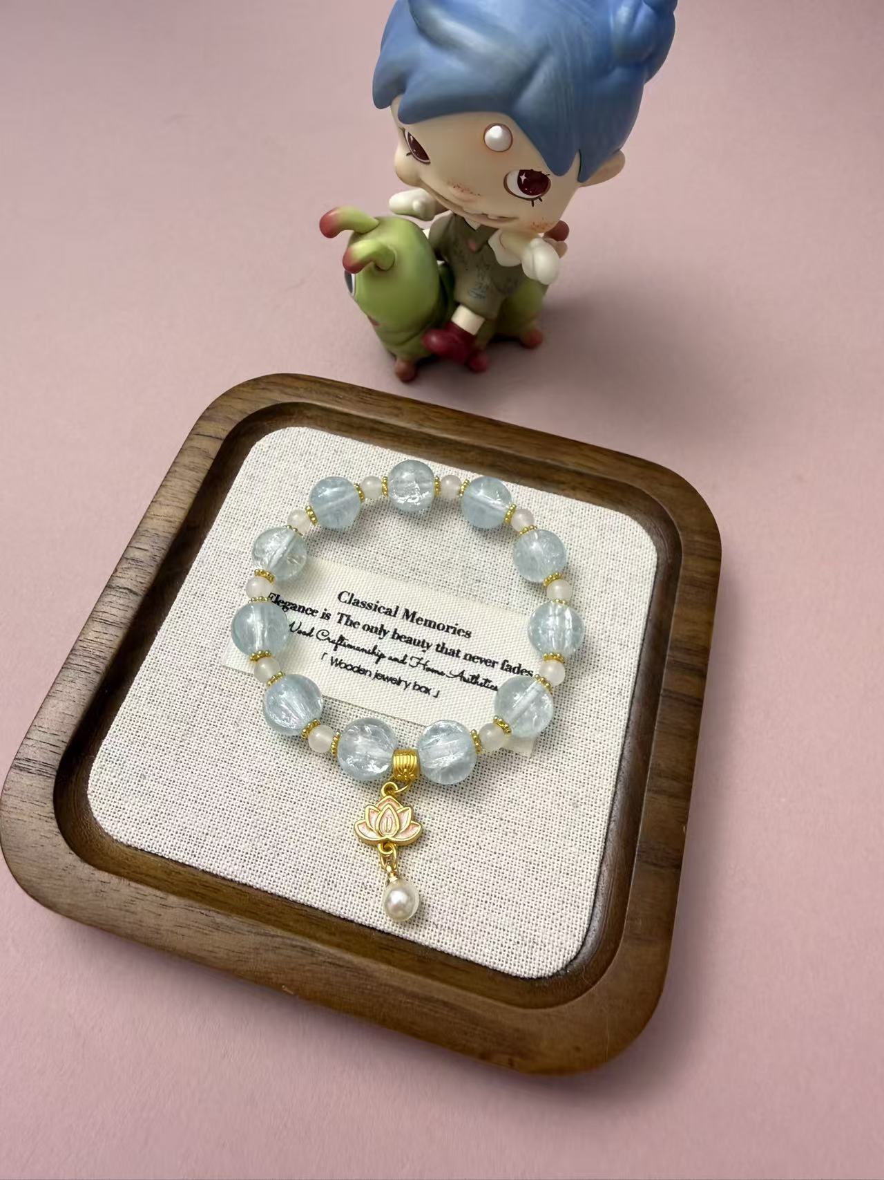 Soft light blue glass bead bracelet with a sweet lotus pearl charm. Minimalist dreamy jewelry for women, ideal for everyday wear or as a cute gift. B111